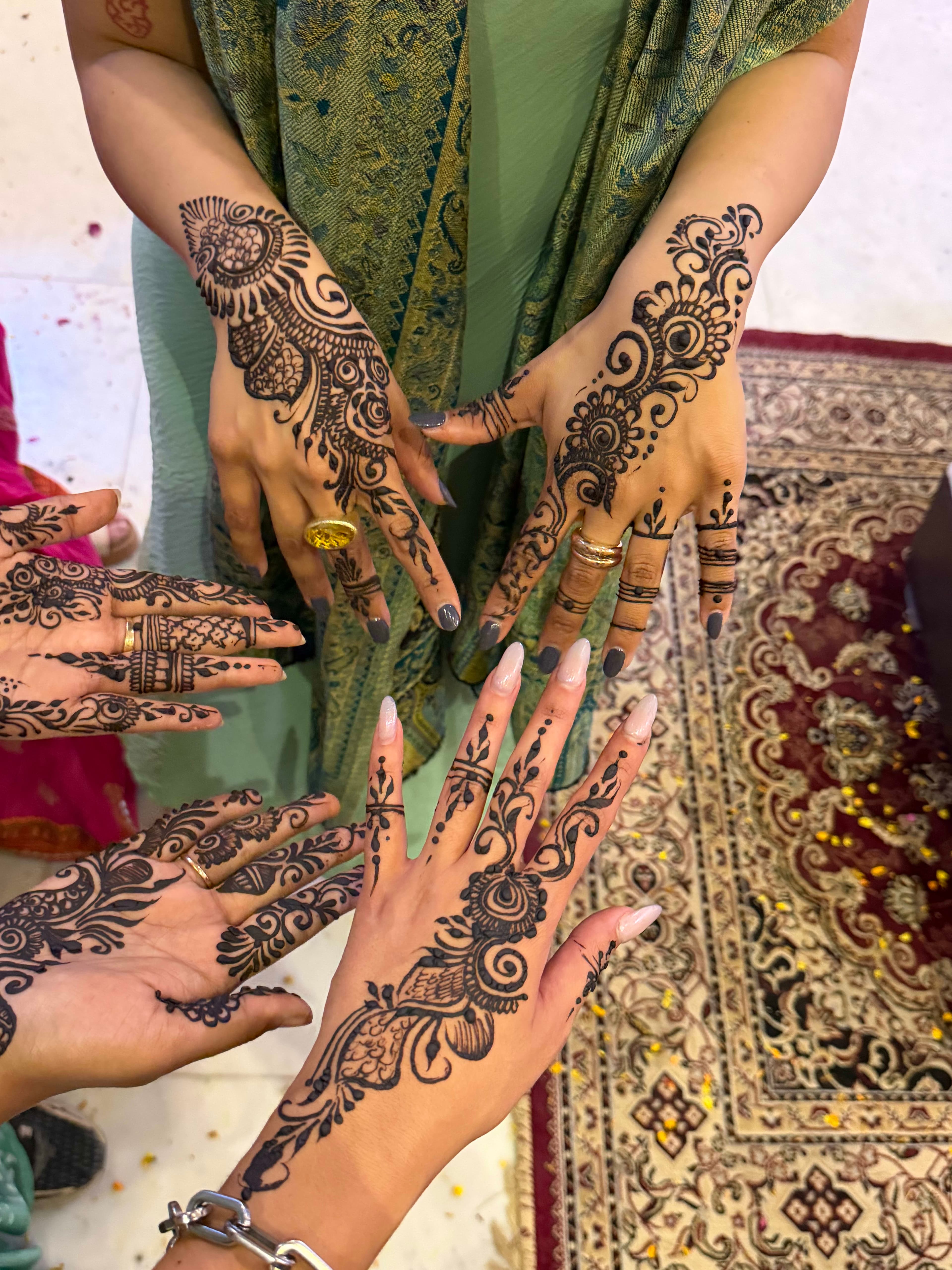 Intricate mehndi henna designs on travellers' hands during the Holi journey