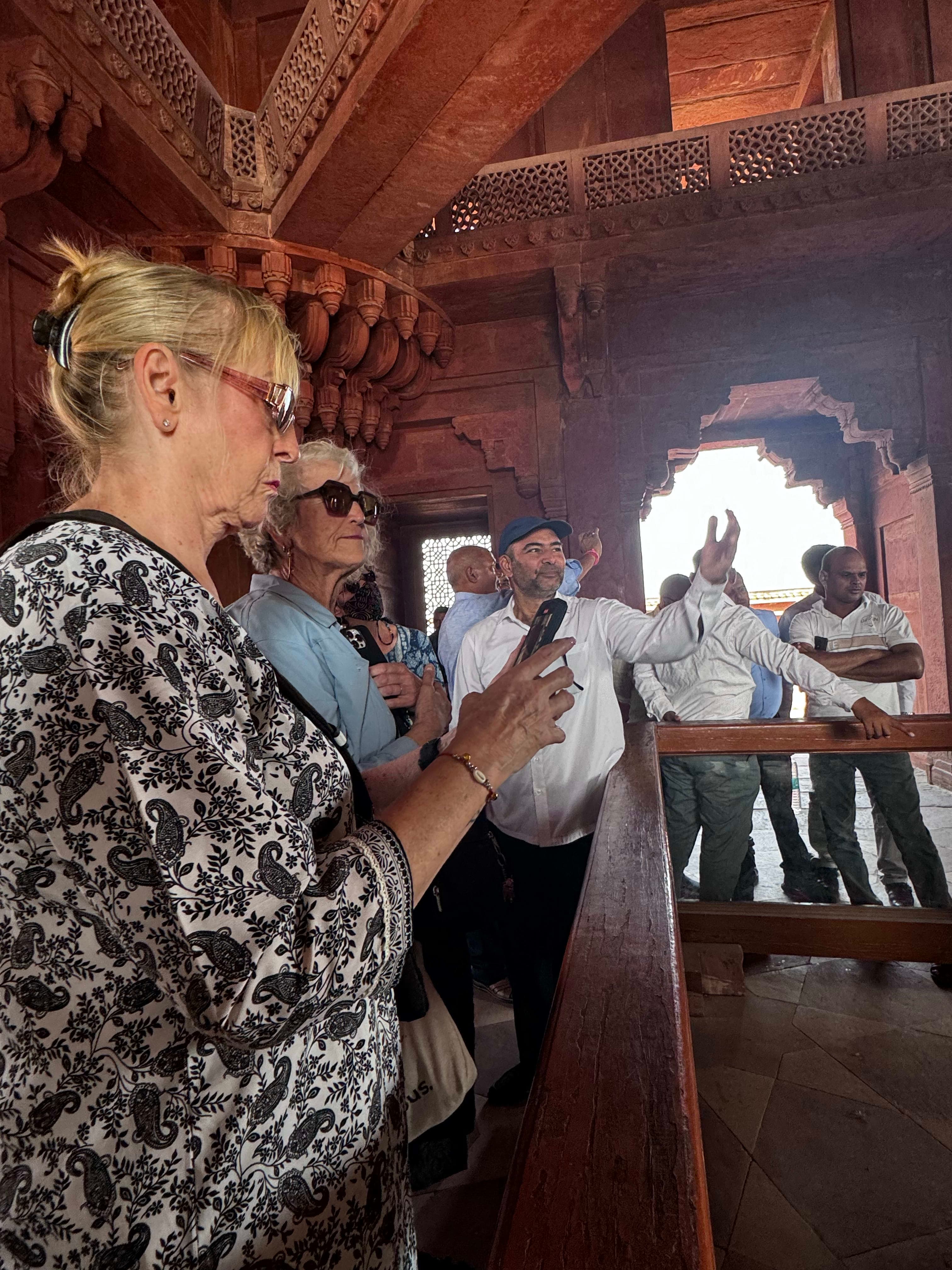 Palm-fringed Kerala backwater with a traditional houseboat gliding through still green water