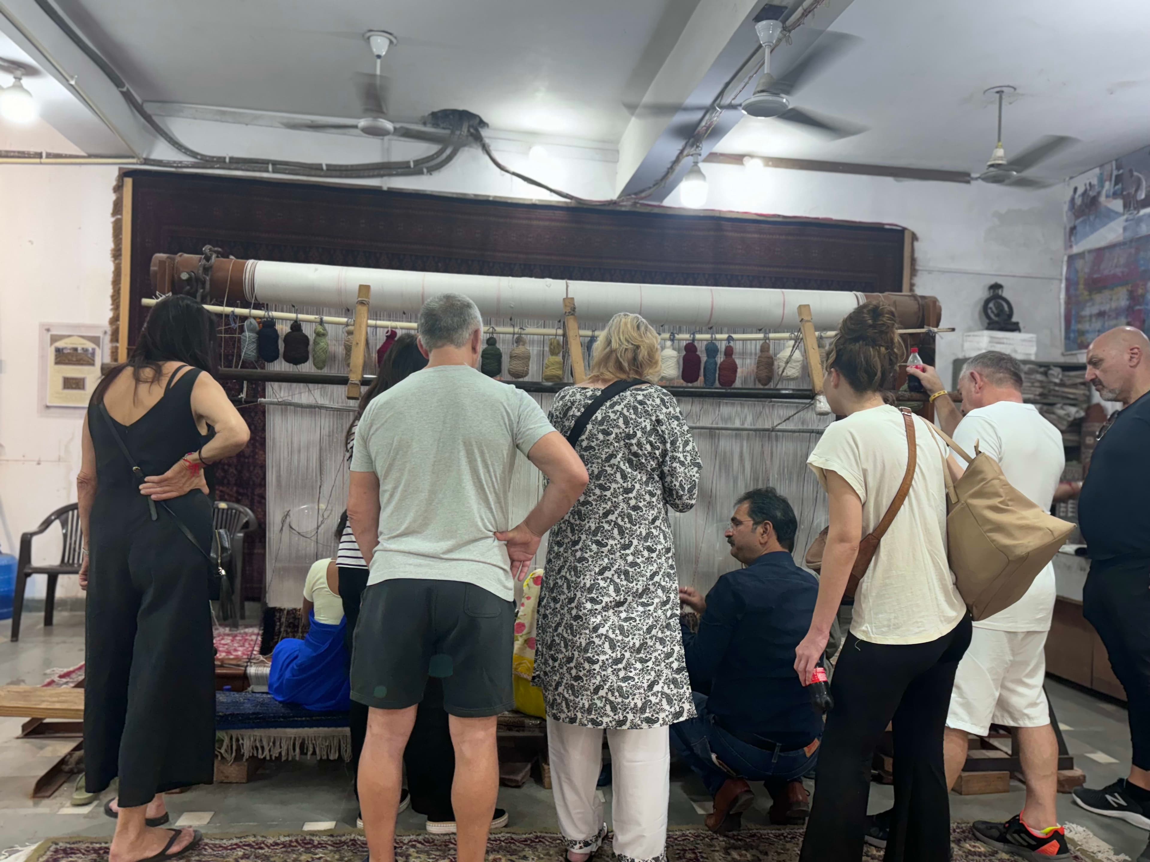 A colourful Indian bazaar stall stacked with textiles and handicrafts