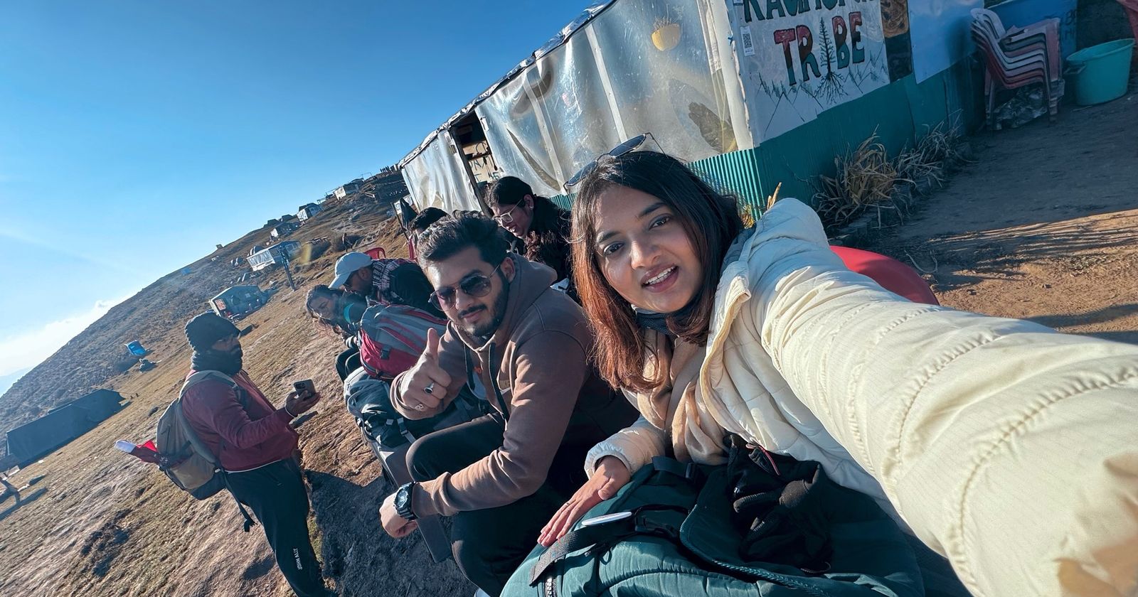 A group of new friends taking a selfie on a sunny mountain top